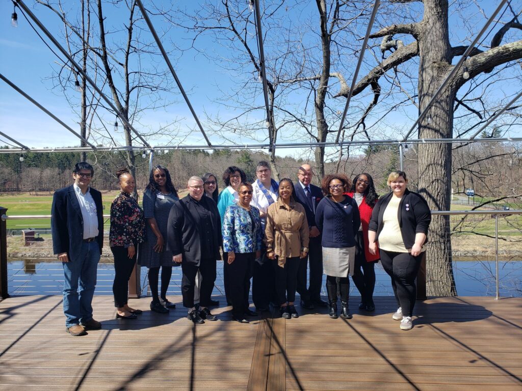 13 Members of LADO on the porch of Smith College Paradise Conference Room, overlooking Paradise Pond